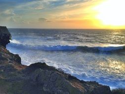 picturesque sunset with foamed waves at cliff, portugal