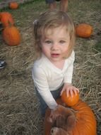 baby and pumpkins