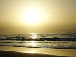 sunlight over a quiet surf