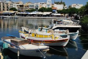 fishing boats near the shore in the city in Crete