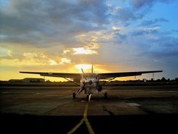 the plane at the airbase at sunset