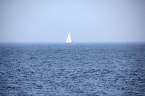 little sailboat in the blue sea