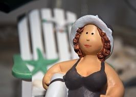 Emmy statuette on the beach with a lap for swimming