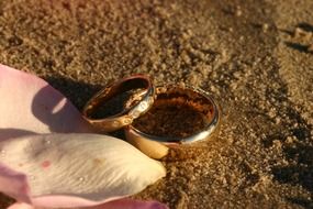 two wedding rings in the sand