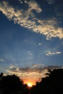 glowing colorful sunset with flocky clouds