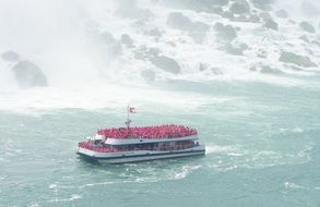 ship with tourists in pink vests
