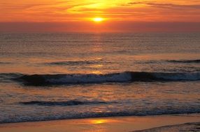 golden sunset, calm sea and sandy beach