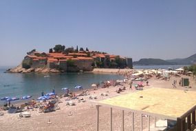 view of scenic village at sea from beach, montenegro, Sveti Stefan