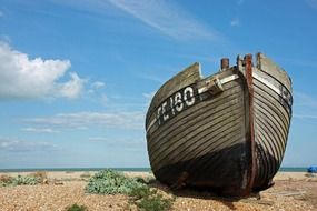 fishing wooden boat on a sandy beach