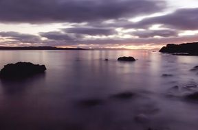 reflection of deep purple sunset sky on sea water