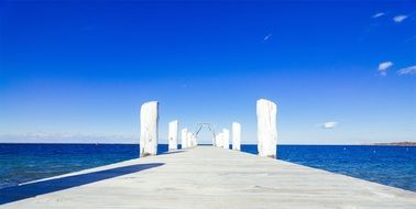 wood dock near blue ocean