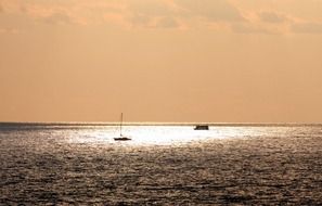 boats on the water in a pink glow