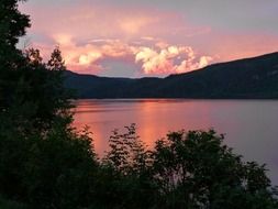 thunderstorm clouds above canim lake at sunset, canada, british columbia