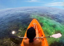 man in a kayak over the reef