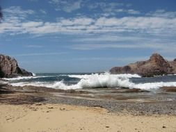 Splashing ocean waves on a stone beach