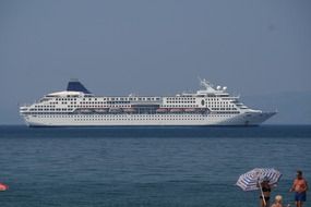 cruise liner sails along the coast