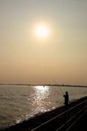fisherman on a evening ocean bank
