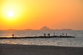 people at ocean in view of coastal city, uae, dubai