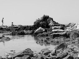 black and white photo of a rocky beach