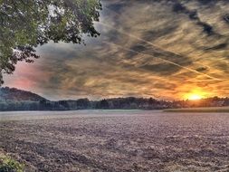 sunset on the horizon of the field