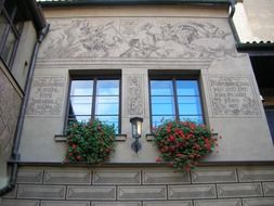 old brewery with hanging flowers on the windows