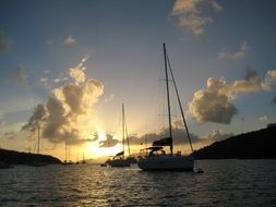 sailing boats in the ocean sunset