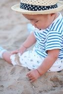 happy kid playing with the sand