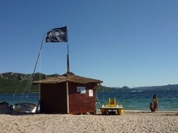 landscape of wooden hut on the sunny Corsica beach