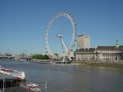 london eye as a ferris wheel by the river