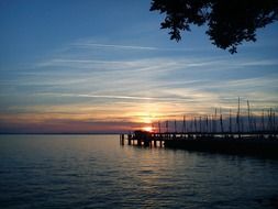 sunset over the lake with a pier