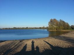 human shadows on a sandy beach