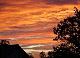 fiery autumn sunset over the barn
