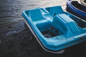 Blue pedalo near the water