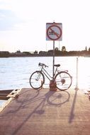 Bicycle near the river and sunset