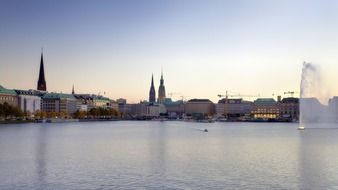 sunset city skyline at binnenalster lake, germany, hamburg