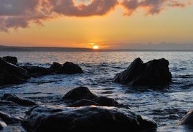 distant view from the coast to the sea sunset on the horizon