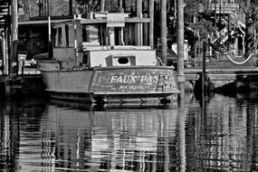 black and white photo of a boat in port
