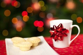 white cup with muffins on a plate