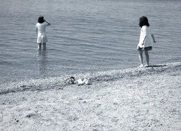 children play on beach monochrome photo