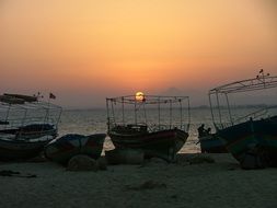 landscape of boats on the beach during sunset