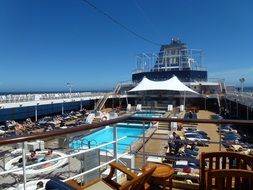 deck of luxury cruise ship with swimming pool