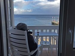 tourist on the balcony at the hotel on the background of the North Sea