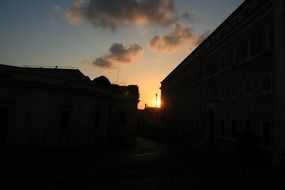 clouds at sunset over the roofs of houses in Italy