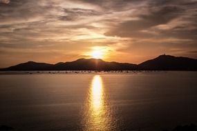reflection of sunset rays in the ocean water at dusk