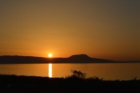 orange sunset under the mountain sea view