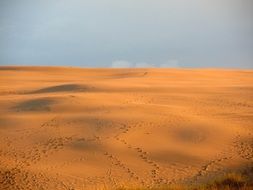 human footprints in the sand dunes