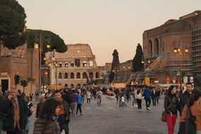 people near the Colosseum at dusk