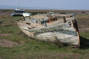 damaged wooden boat on the shore