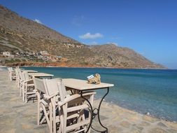 chairs and tables on the coast of the island of Crete