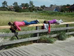 lazing around scene with people on fence